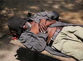 A homeless man rests on a bench in Baltimore. CNS Photo/Bob Roller