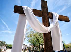 A cross draped with a white sash for Easter is seen on the campus of St. Peter Indian Mission School in Bapchule, Arizona. CNS Photo/Nancy Wiechec