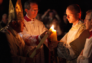 Pope Benedict XVI lights a candle at the 2011 Easter Virgil at the Vatican. CNS Photo/Paul Haring