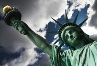The Statue of Liberty torch against the background of a stormy sky. iStock image used for illustrative purposes only.