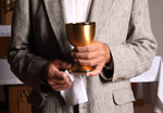 Layman holds chalice. 