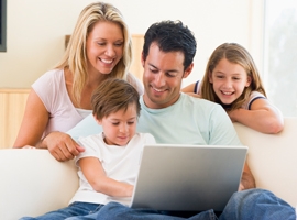 a family reads material on a laptop
