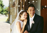 Couple smiling at their wedding.