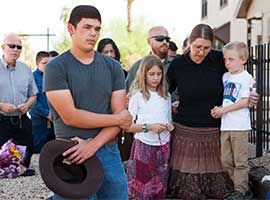 Parishioners pray the rosary near Mater Misericordiae (Mother of Mercy) Mission in Phoenix after a priest was killed and another critically injured during an attack at the mission in June 2014. CNS photo/Nancy Wiechec