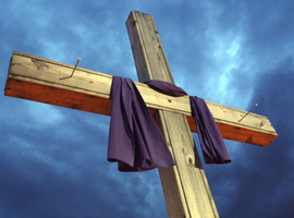 A simple wooden cross is draped in purple for Lent.  CNS Photo/Gregory A. Shemitz/Long Island Catholic.