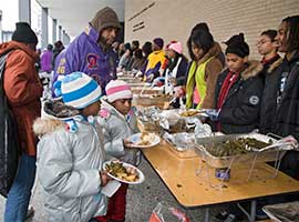 Two young girls receive food at an outdoor soup kitchen in Washington in late January, 2009. CNS photo/Jim West
