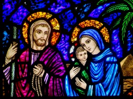 A detail of a stained-glass window from St. Edward's Church in Seattle shows Jesus, Mary and Joseph on their flight into Egypt. CNS Photo/Crosiers
