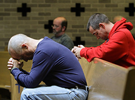Men praying (CNS photo/Gregory A. Shemitz, Long Island Catholic)
