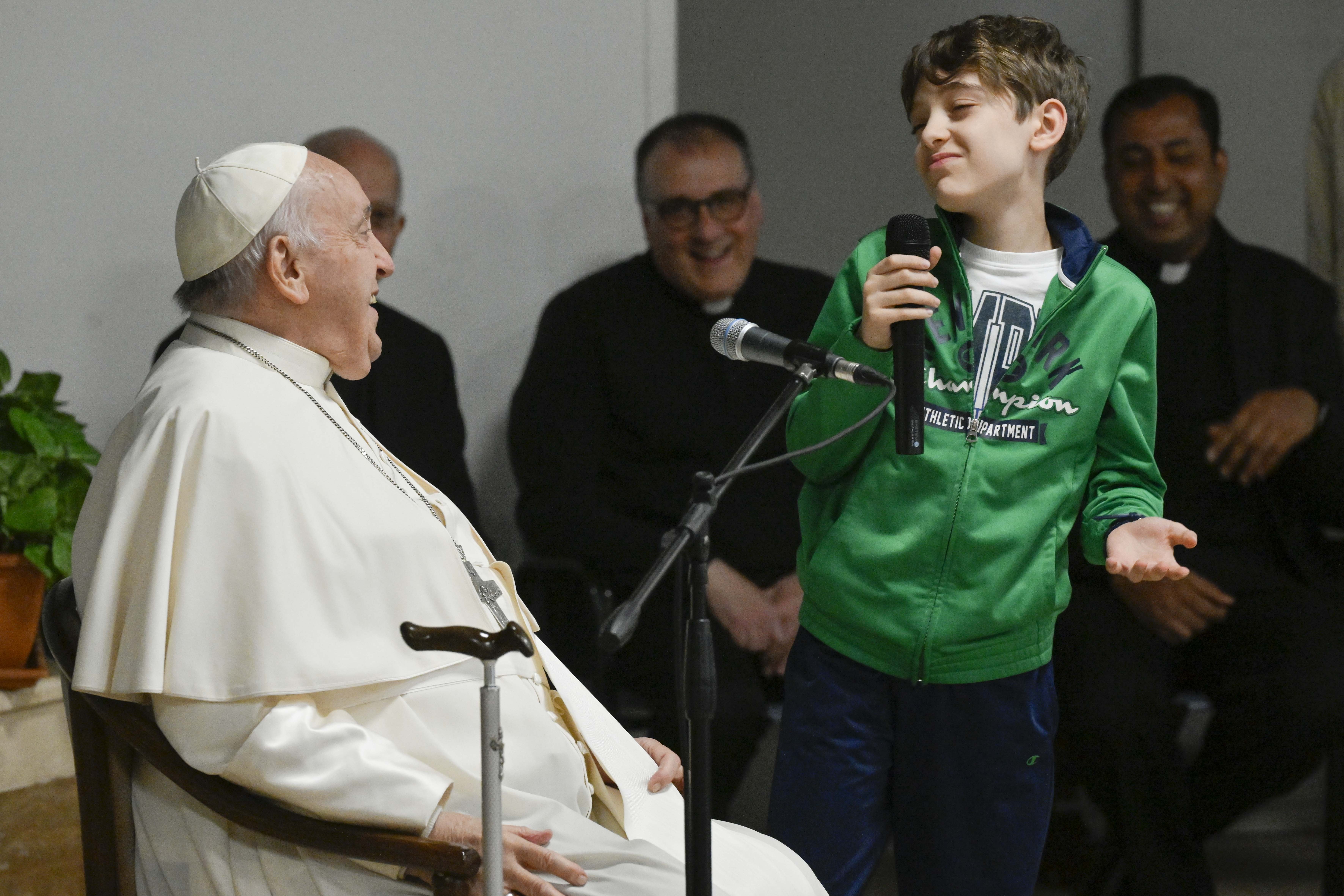 Pope Francis listens to a boy's question