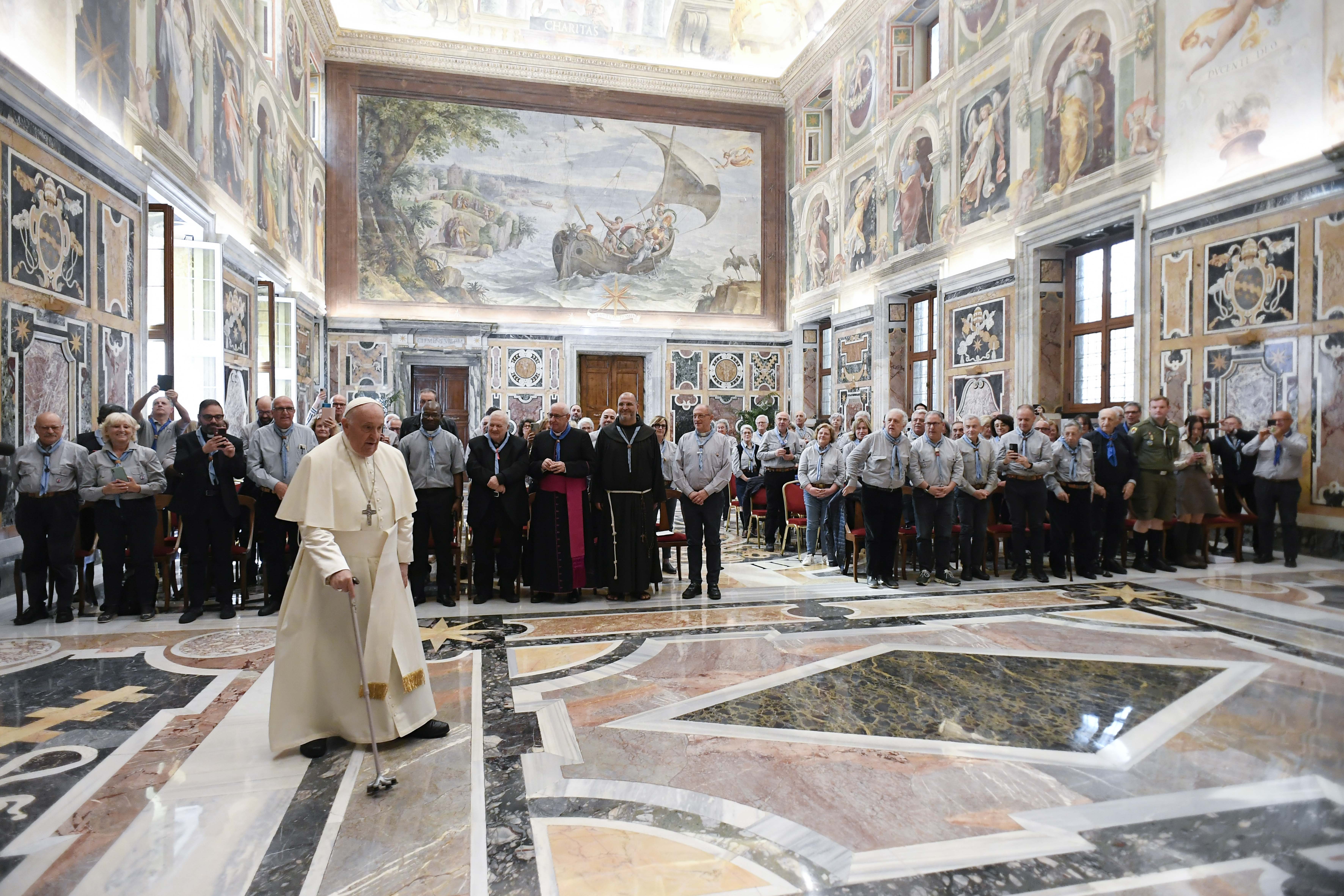 Pope Francis enters the Clementine Hall at the Vatican for a meeting with members of the Italian Catholic Movement of Adult Scouts.