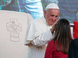 Pope Francis greets a young woman as he leads a meeting with young people along the waterfront in Asuncion, Paraguay, July 12, 2015. CNS photo/Paul Haring