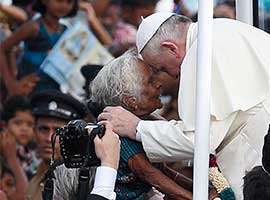 Pope Francis greets an elderly woman as he arrives to pray at the Sanctuary of Our Lady of the Rosary in Madhu, Sri Lanka, in January, 2014. CNS photo/Paul Haring