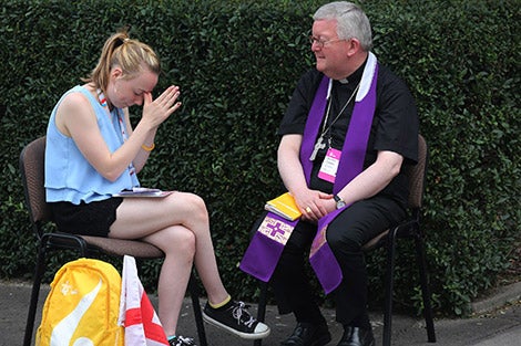 A World Youth Day pilgrim becomes emotional as a priest hears her confession at Sacred  Heart Church in Krakow, Poland, July 28. (CNS photo/Bob Roller)