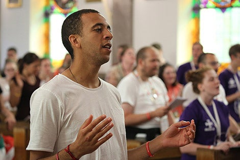 Sean Goug, 26, of England, prays at Sacred  Heart Church in Krakow, Poland, July 28. (CNS photo/Bob Roller)