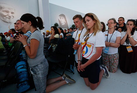 World Youth Day pilgrims kneel in prayer July 30 as Pope Francis leads the benediction during a prayer vigil at the Field of Mercy in Krakow, Poland. (CNS photo/Paul Haring)