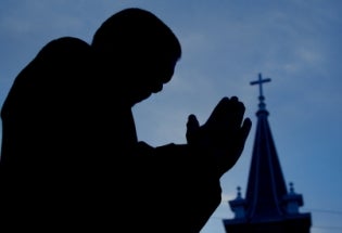 man-praying-silhouette-church-iStock-home