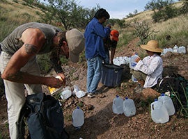 Volunteers with the humanitarian group No More Deaths leave food and water for illegal immigrants crossing into the Arizona desert from Mexico. CNS photo/J.D. Long-Garcia, Catholic Sun Volunteers with the humanitarian group No More Deaths leave food and water for illegal immigrants crossing into the Arizona desert from Mexico. CNS photo/J.D. Long-Garcia, Catholic Sun