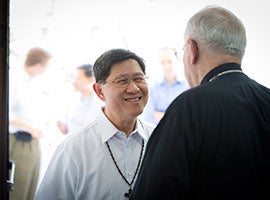 Philippine Cardinal Luis Tagle of Manila greets Archbishop Joseph E. Kurtz, president of the U.S. Conference of Catholic Bishops, in the Philippine capital Manila in February 2014. CNS photo/Tyler Orsburn