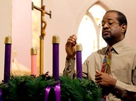 Joe Brooks lights the first candle of the Advent wreath at St. Joseph's Catholic Church in Alexandria, Va.   CNS photo/Nancy Phelan Wiechec