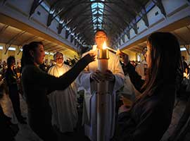 The Paschal Candle is lit at an  Easter Vigil service at Our Lady of Lourdes Parish in De Pere, Wisc. CNS photo/Sam Lucero, The Compass