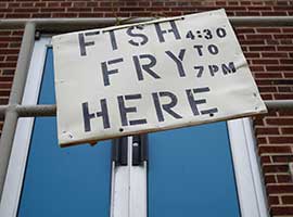 A sign hangs outside the parish hall of St. Mary's Church in Altoona, Pa., prior to a Friday Lenten fish fry.  CNS photo/Bob Roller