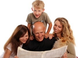 Family reading newspaper