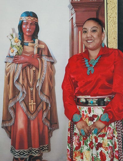 Teresa Tsoie along side mural