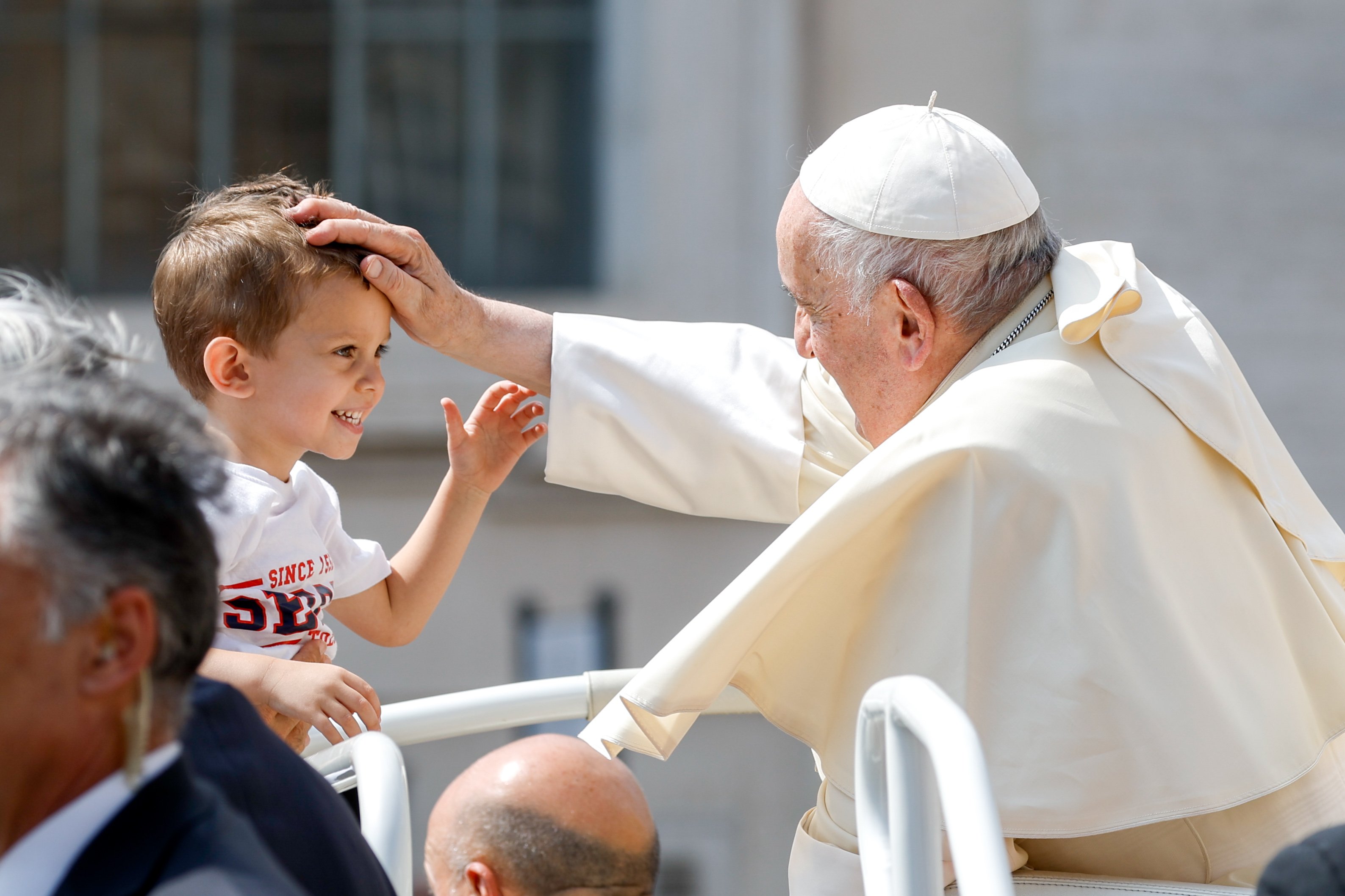 Pope Francis greets a child.