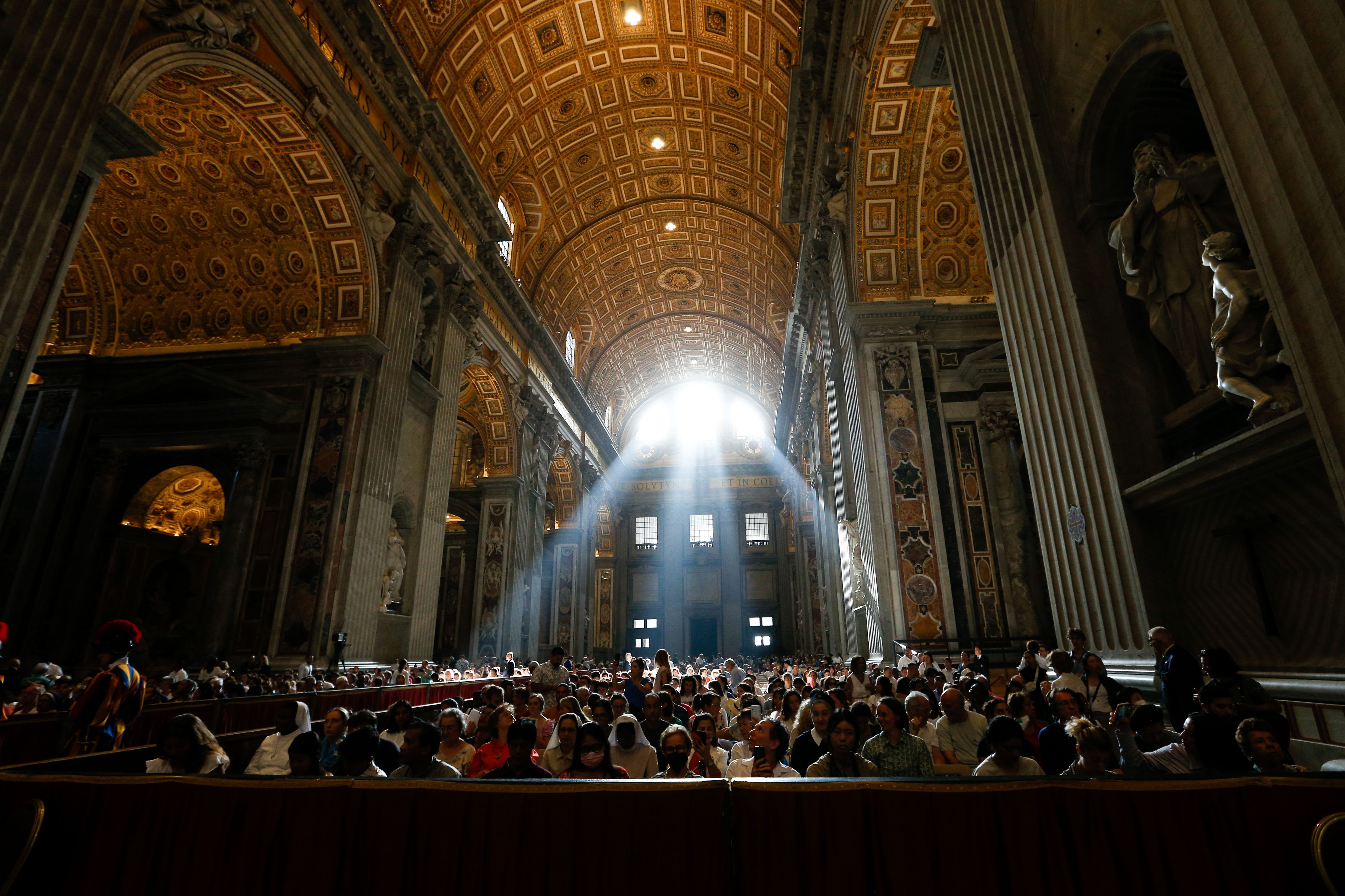 Light streams in through windows in St. Peter's Basilica.