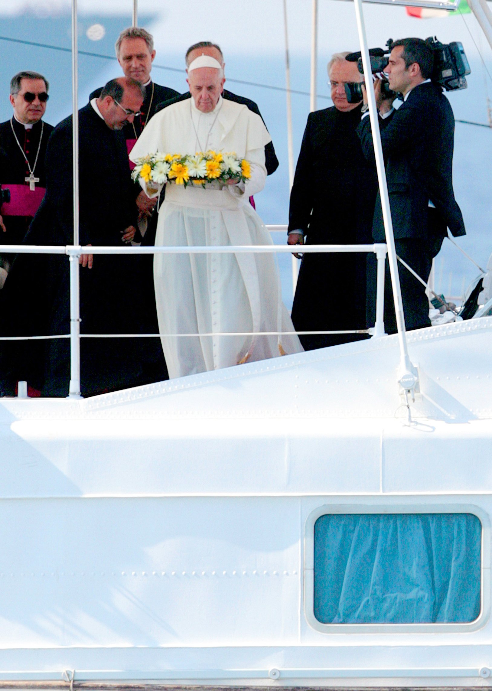 Pope throws wreath into sea.
