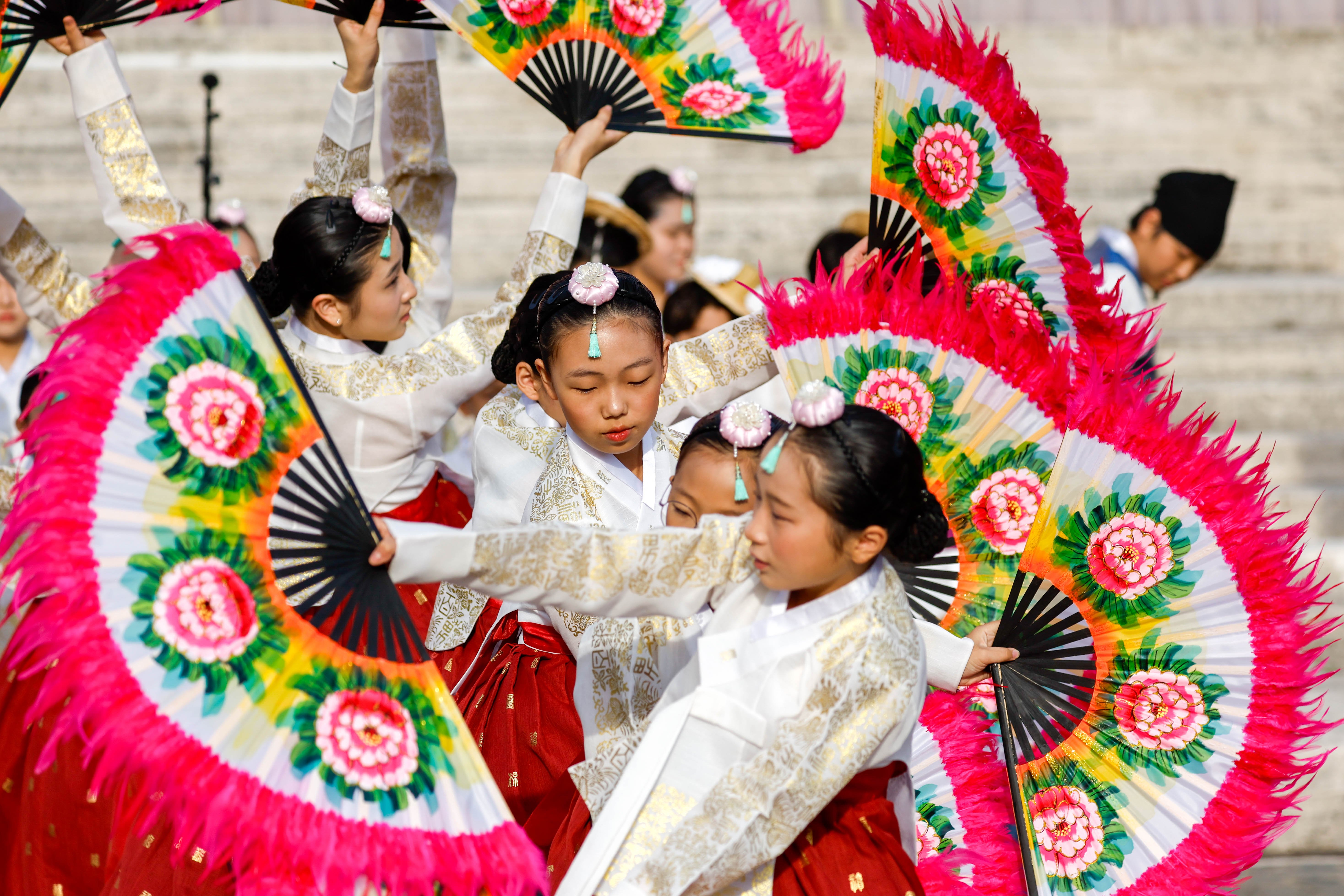 A troupe of dancers from South Korea performs in St. Peter's Square.