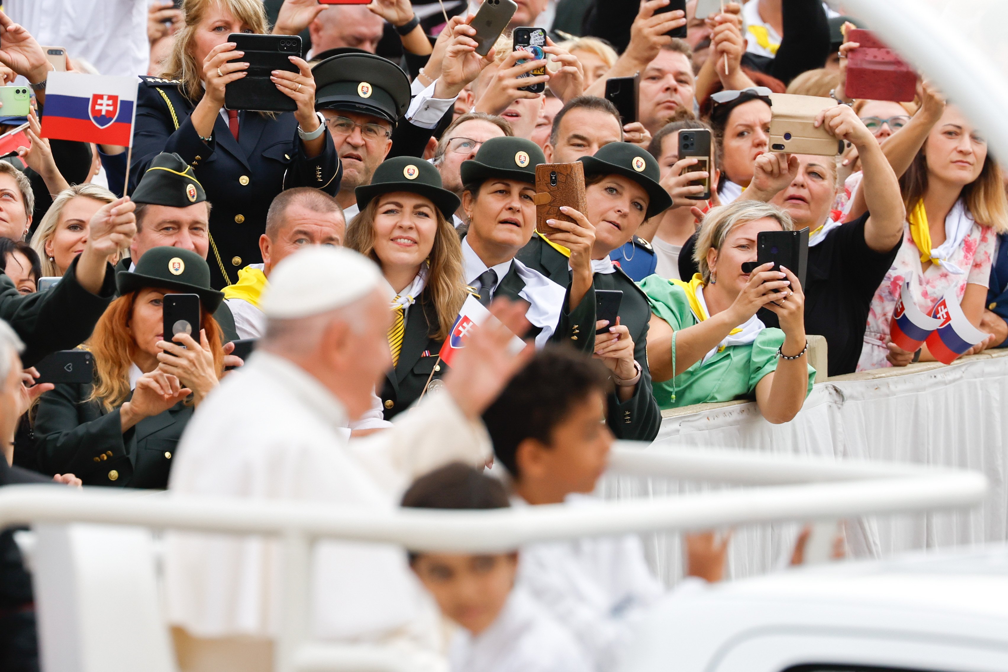 Pope Francis waves to visitors from the popemobile.
