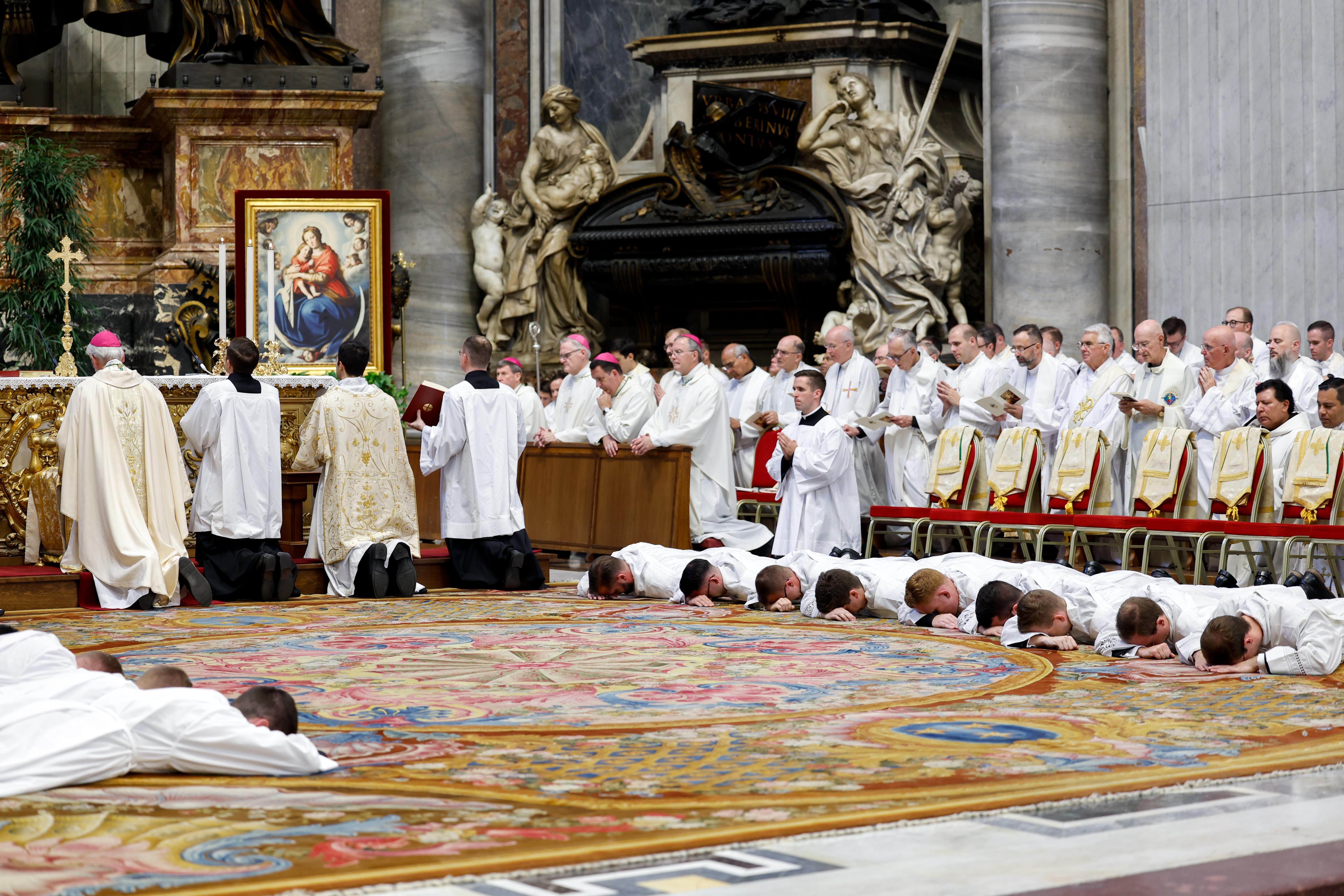 New deacons from the Pontifical North American College in Rome lie prostrate during their ordination in St. Peter's Basilica.