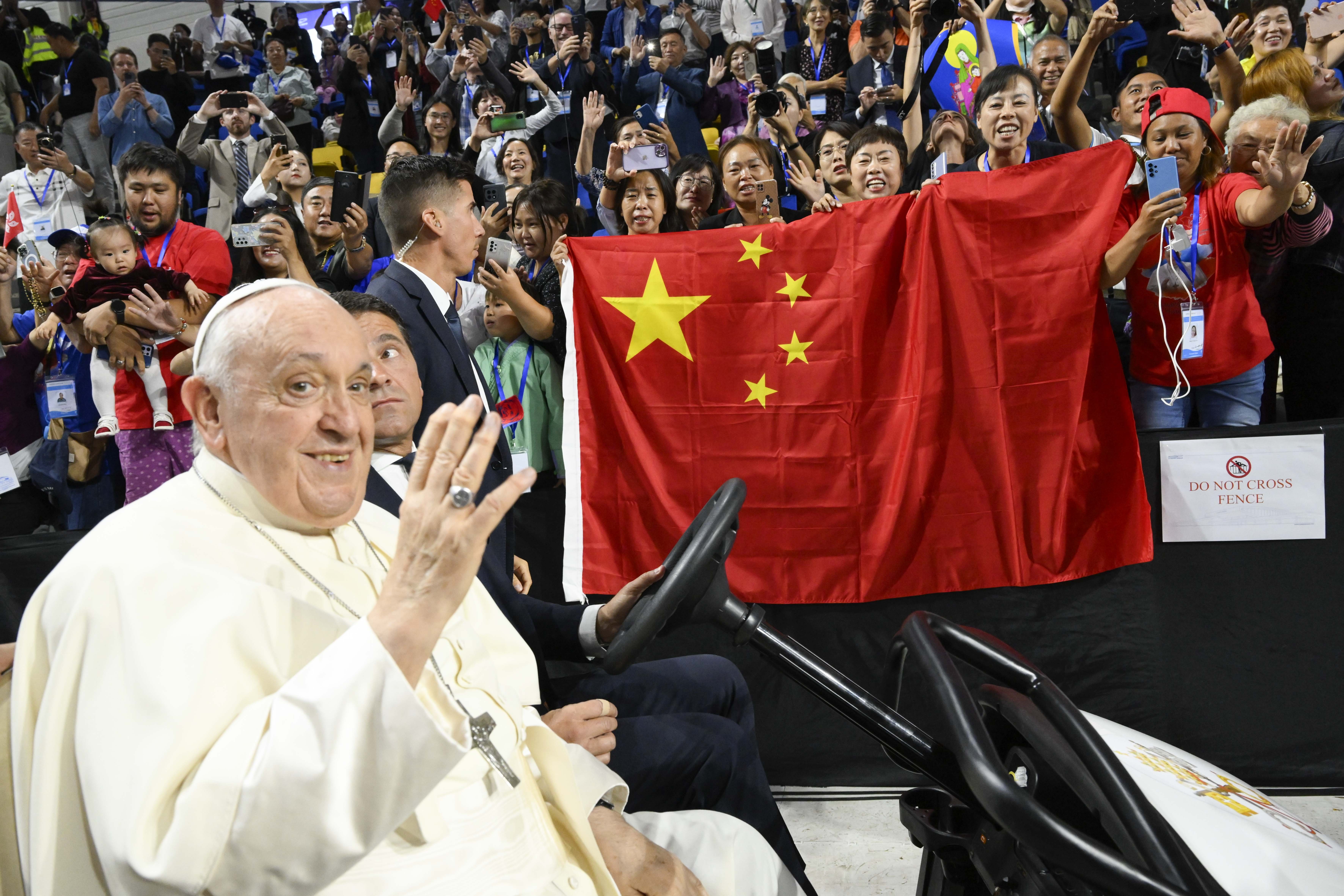 Pope Francis before a Chinese flag. 