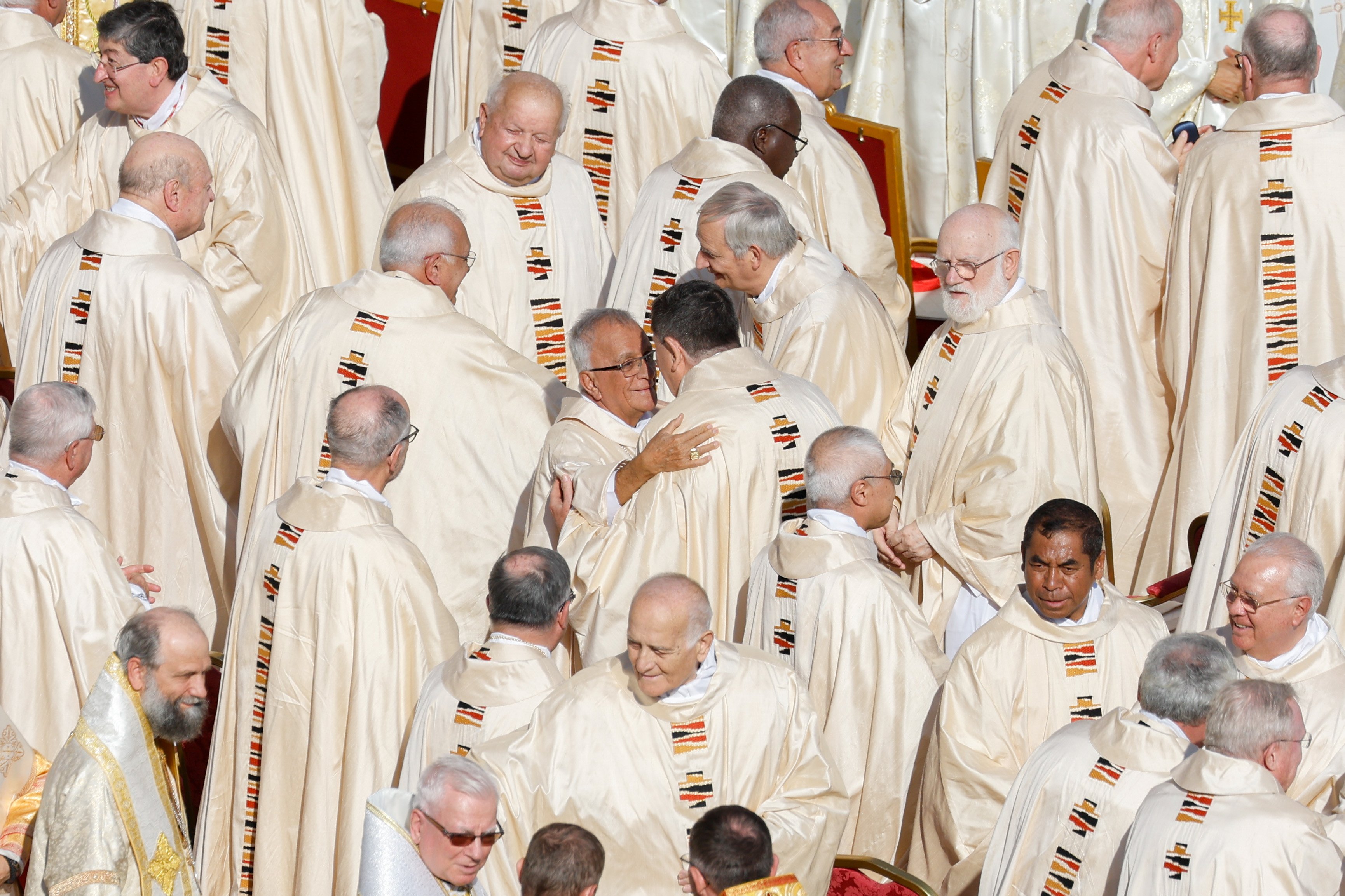 Cardinals and bishops exchange a sign of peace.