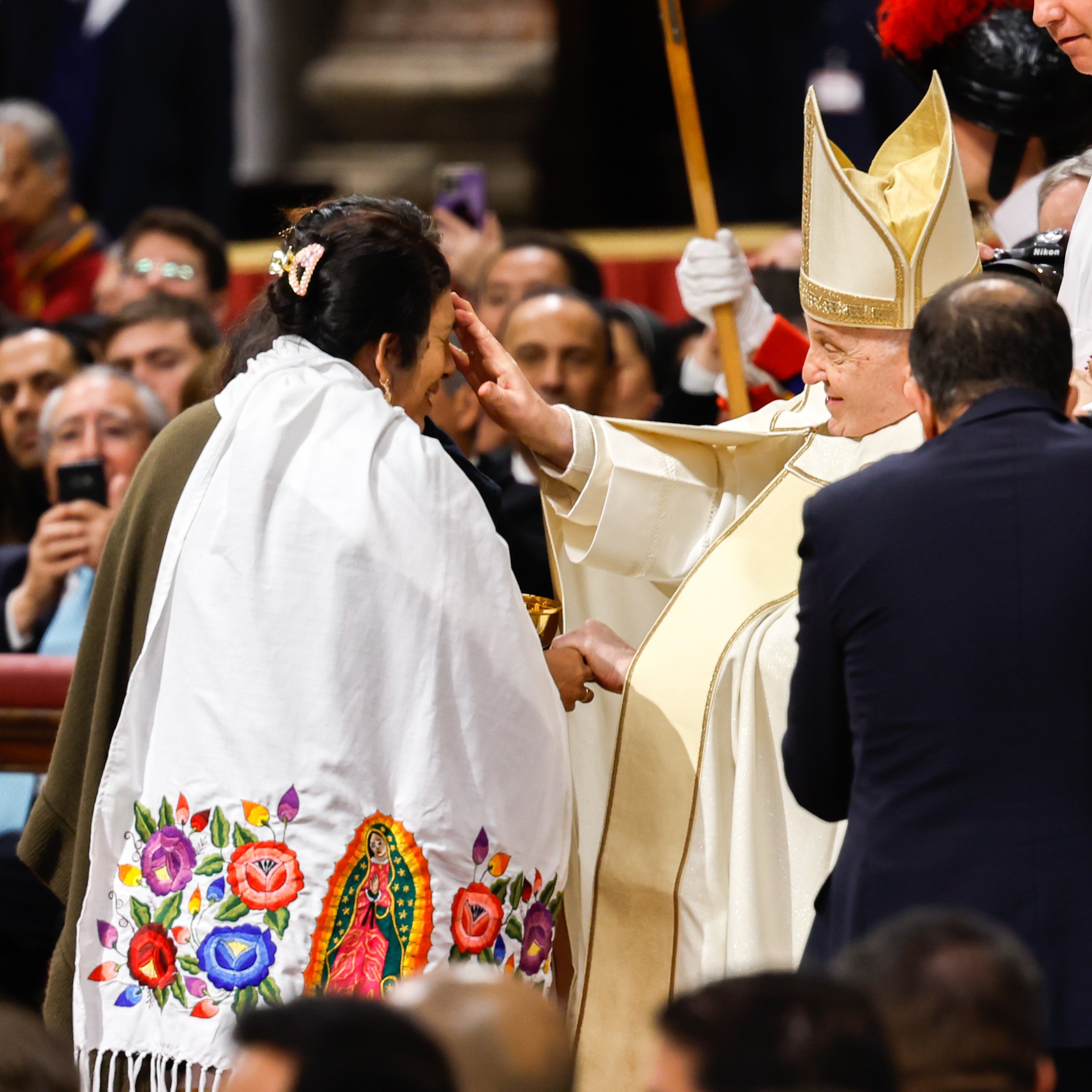 Pope Francis greets a woman.