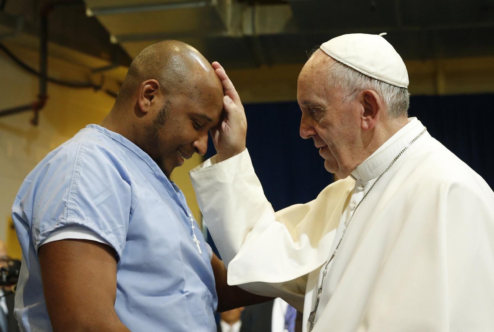 Pope Francis blesses a prisoner