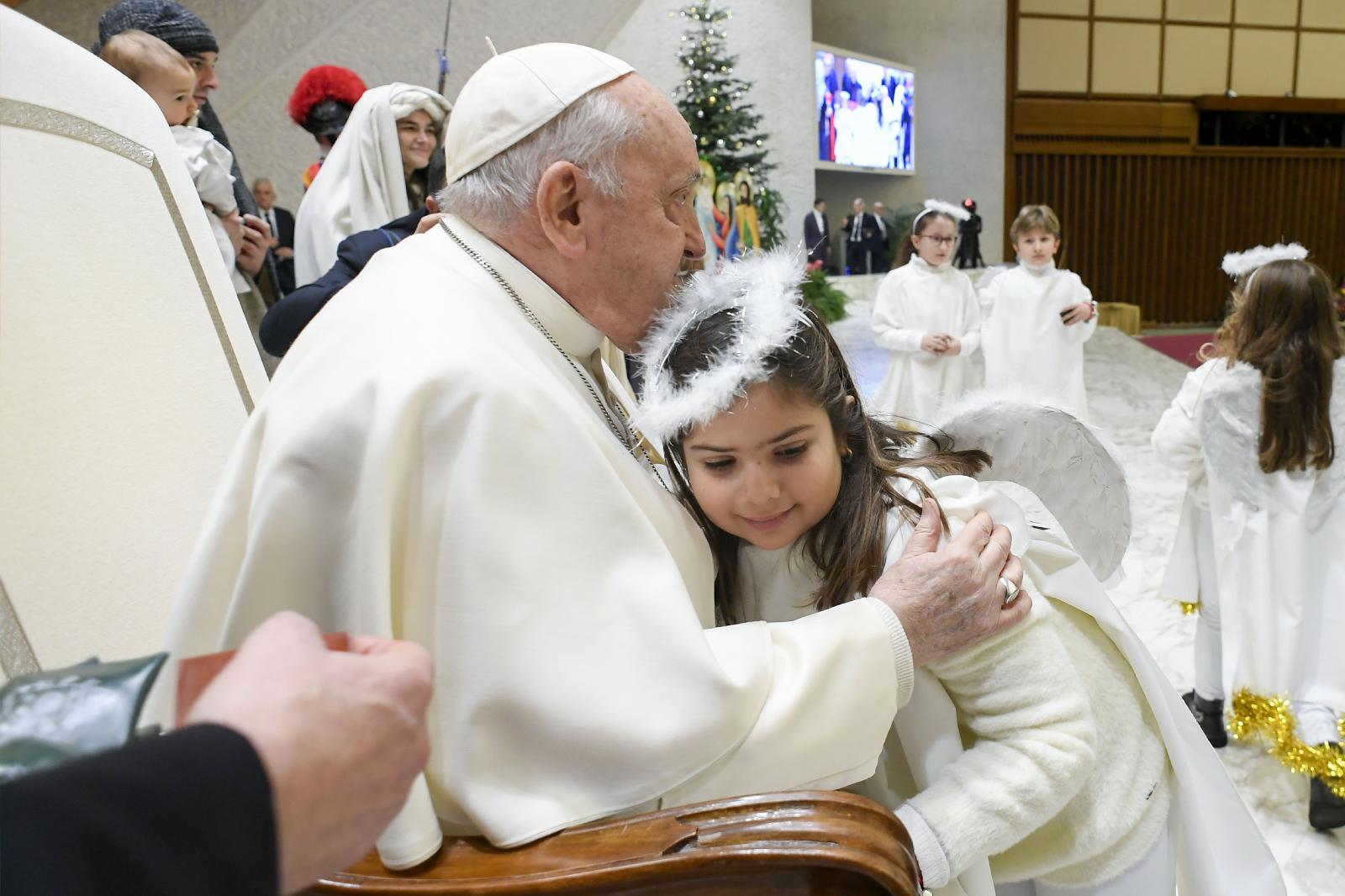 Pope Francis gets a hug from an angel