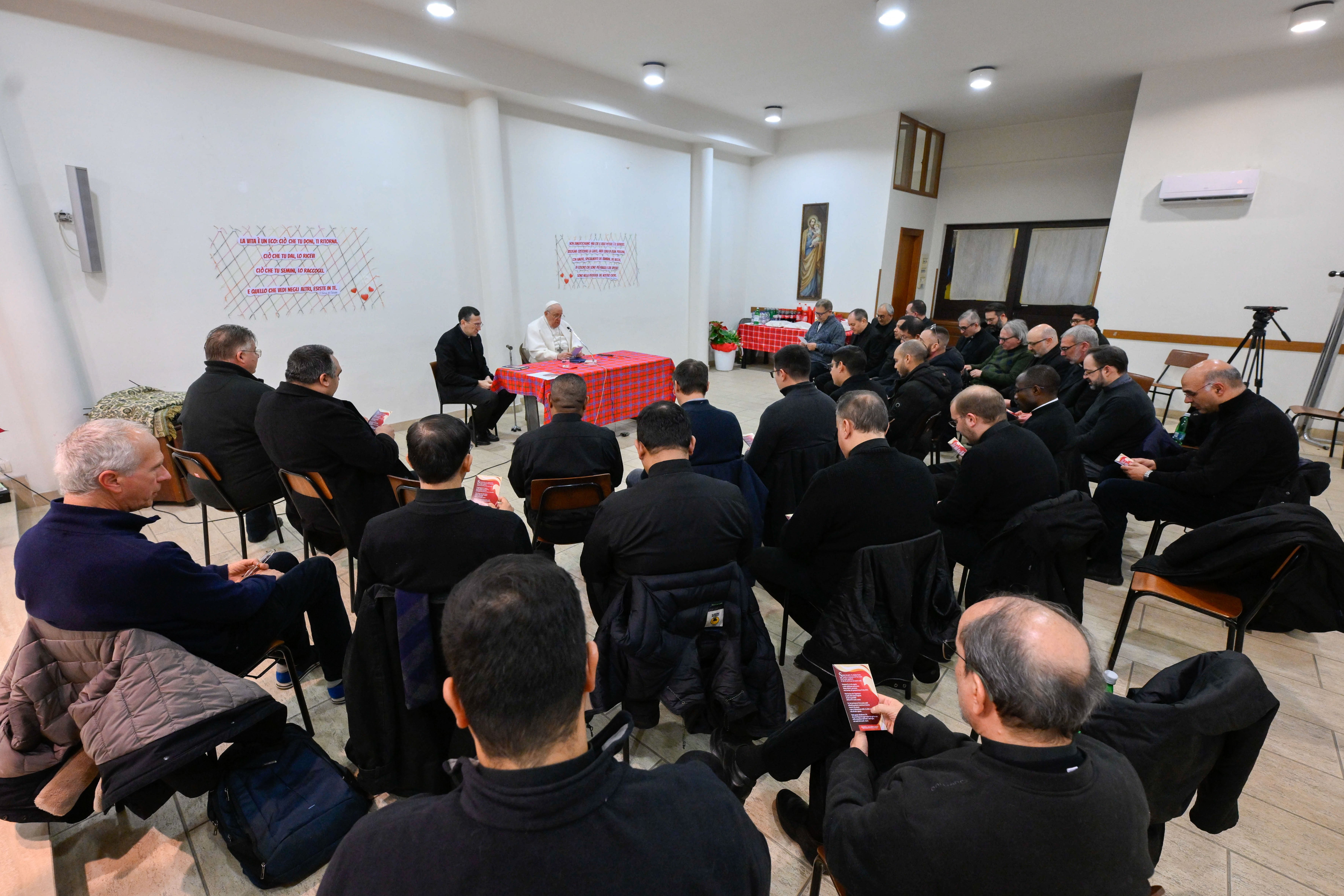 Pope Francis meets with a group of priests.