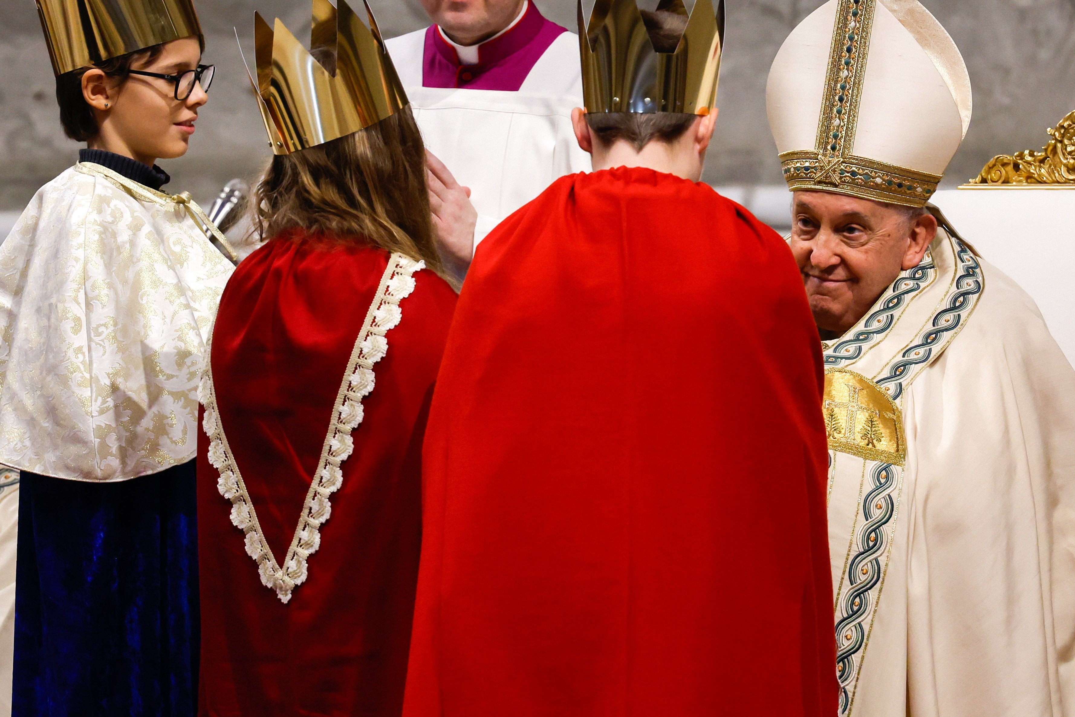 Pope Francis greets children dressed as the Magi.