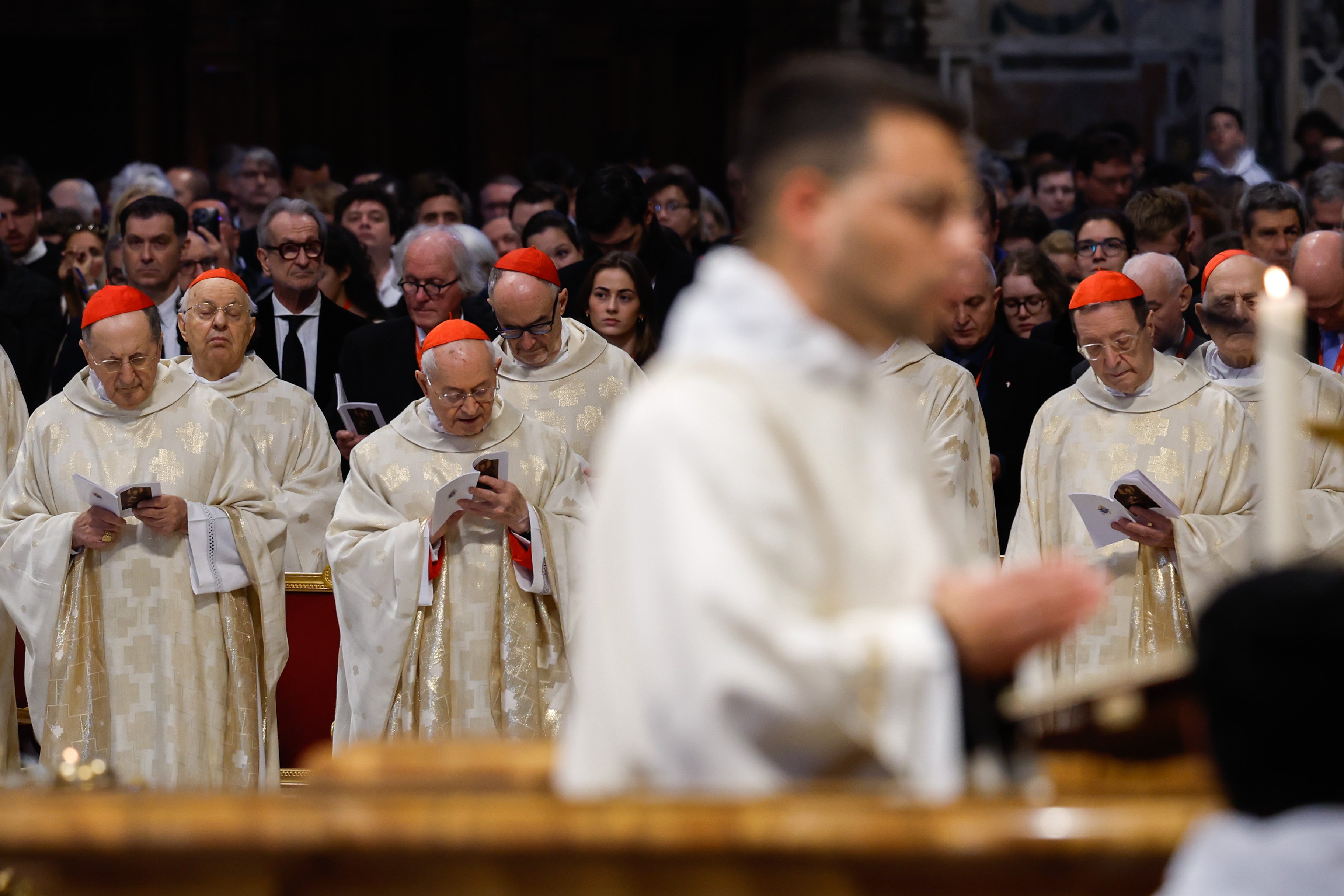 Cardinals pray as the Gospel is read during Pope Francis' Mass.