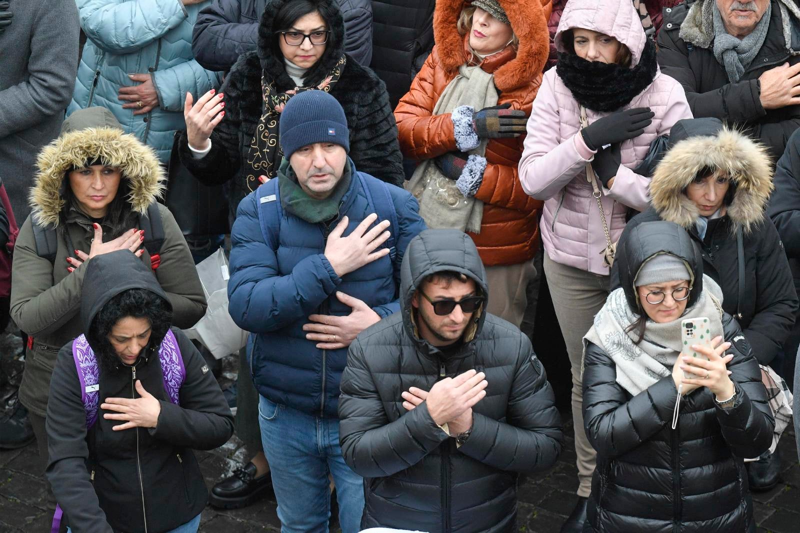 People make the sign of the cross