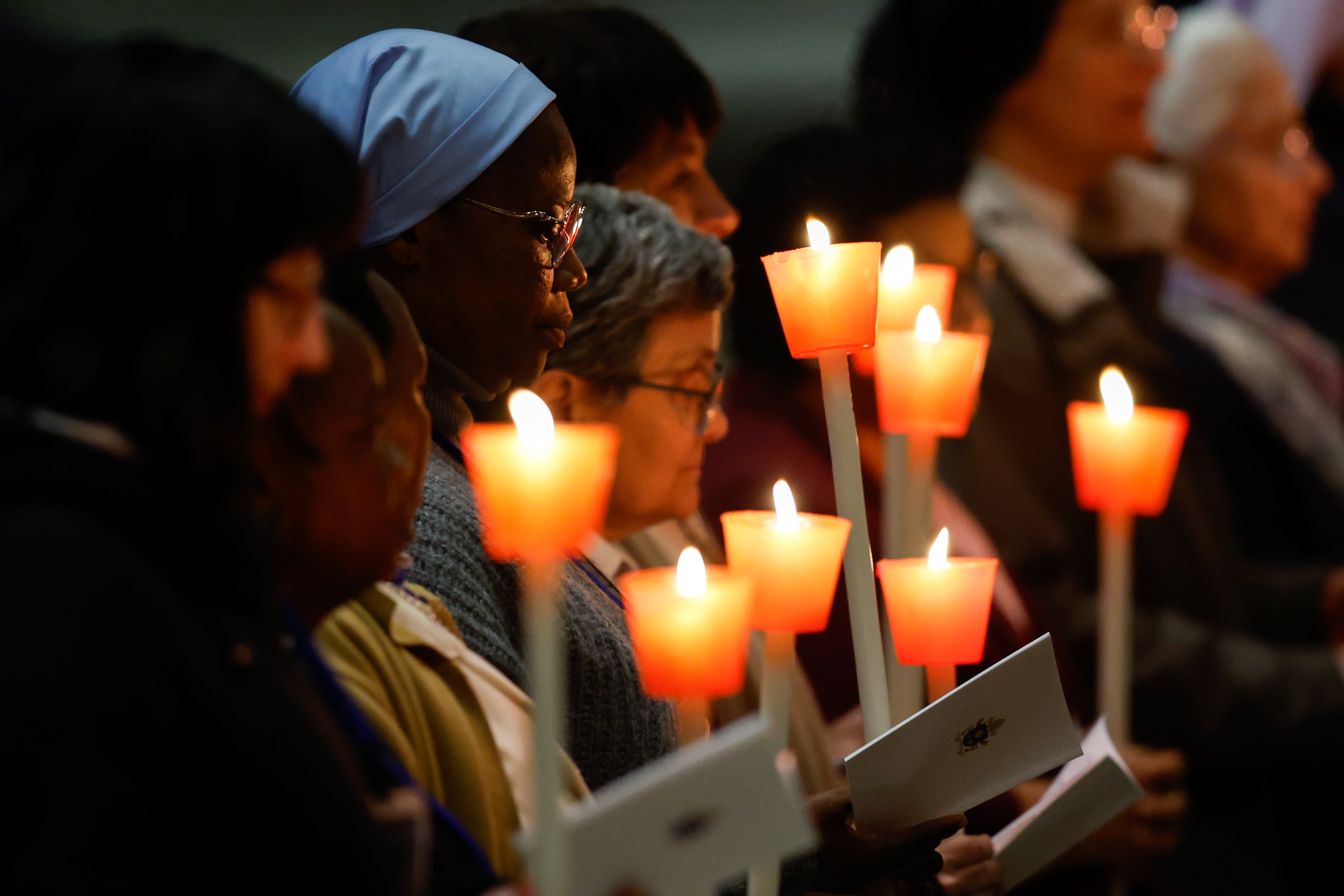 Consecrated women hold candles.