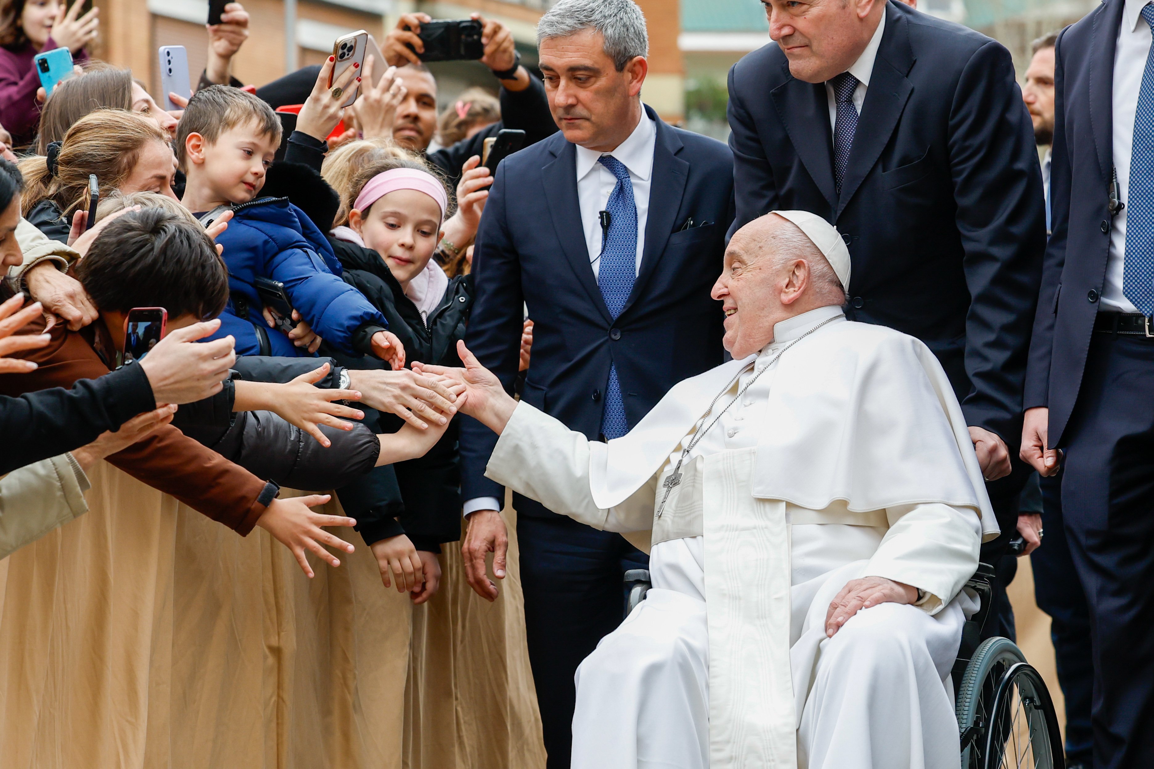 Pope Francis greets children.