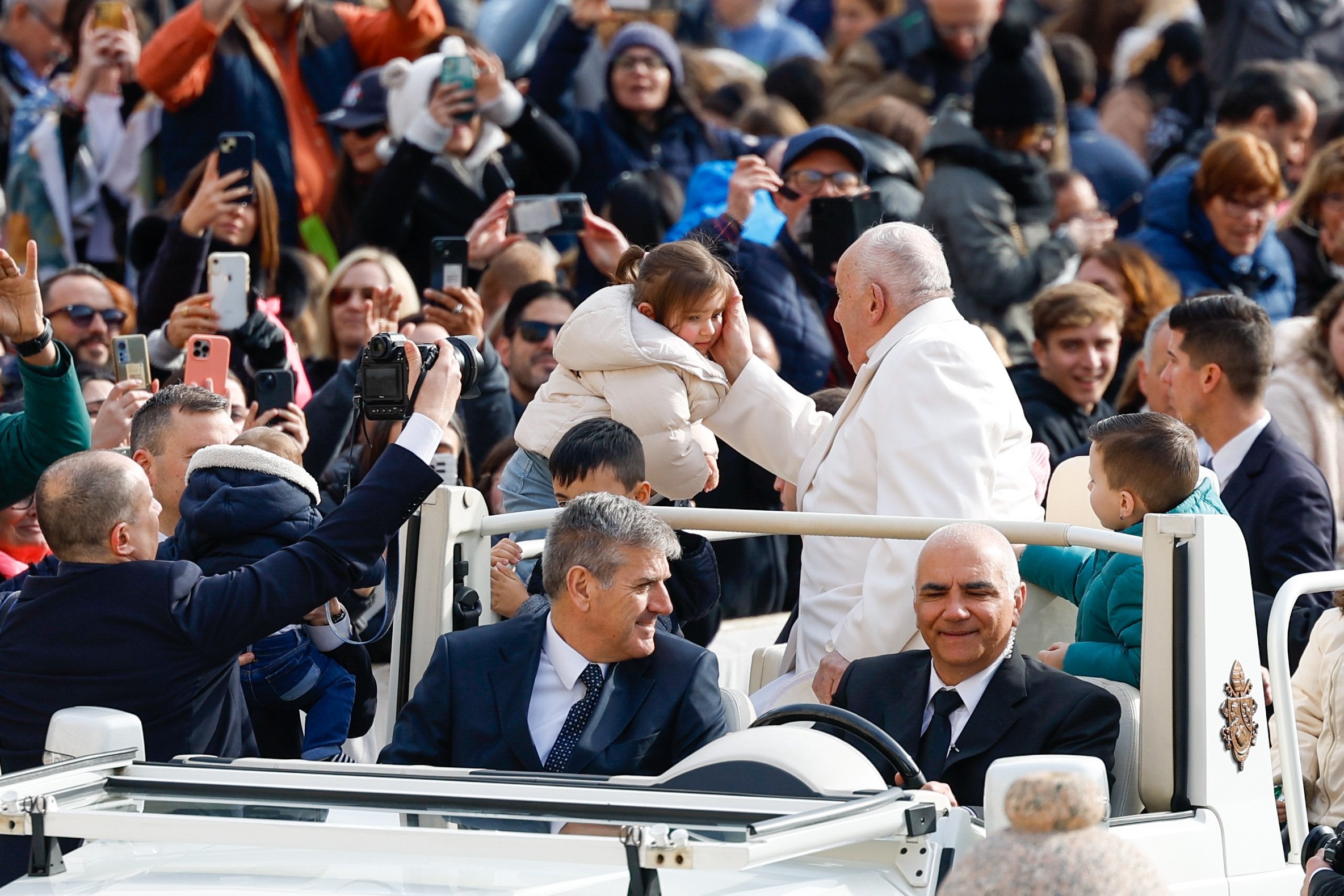 Pope Francis greets a child.