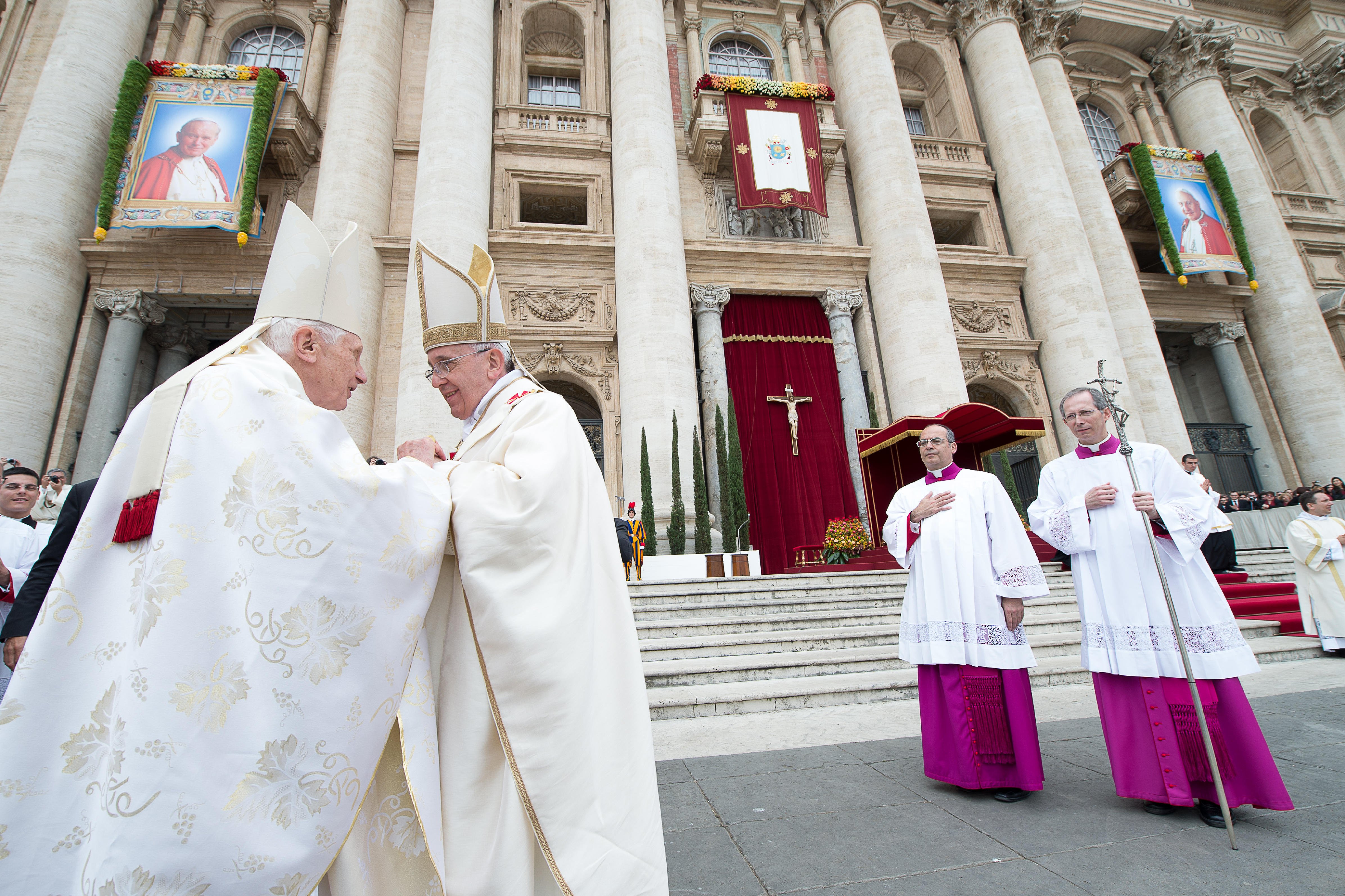 Pope Francis greets Pope Benedict XVI.