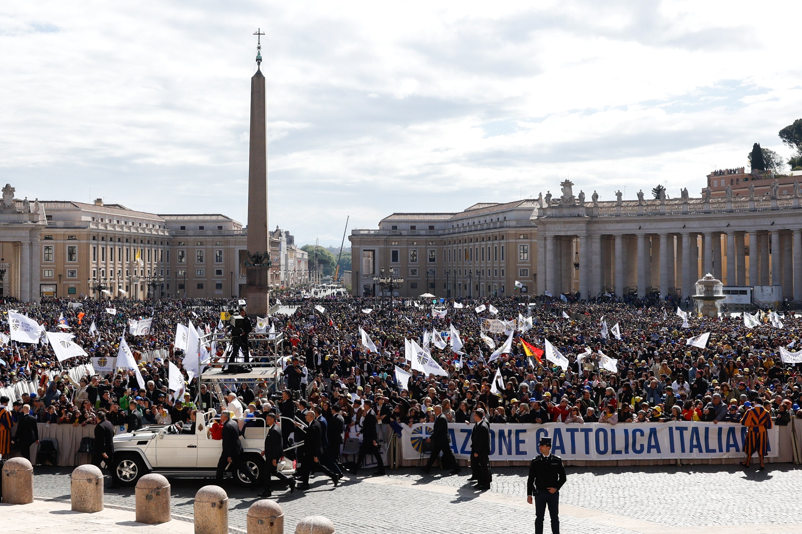 Pope Francis greets people. 