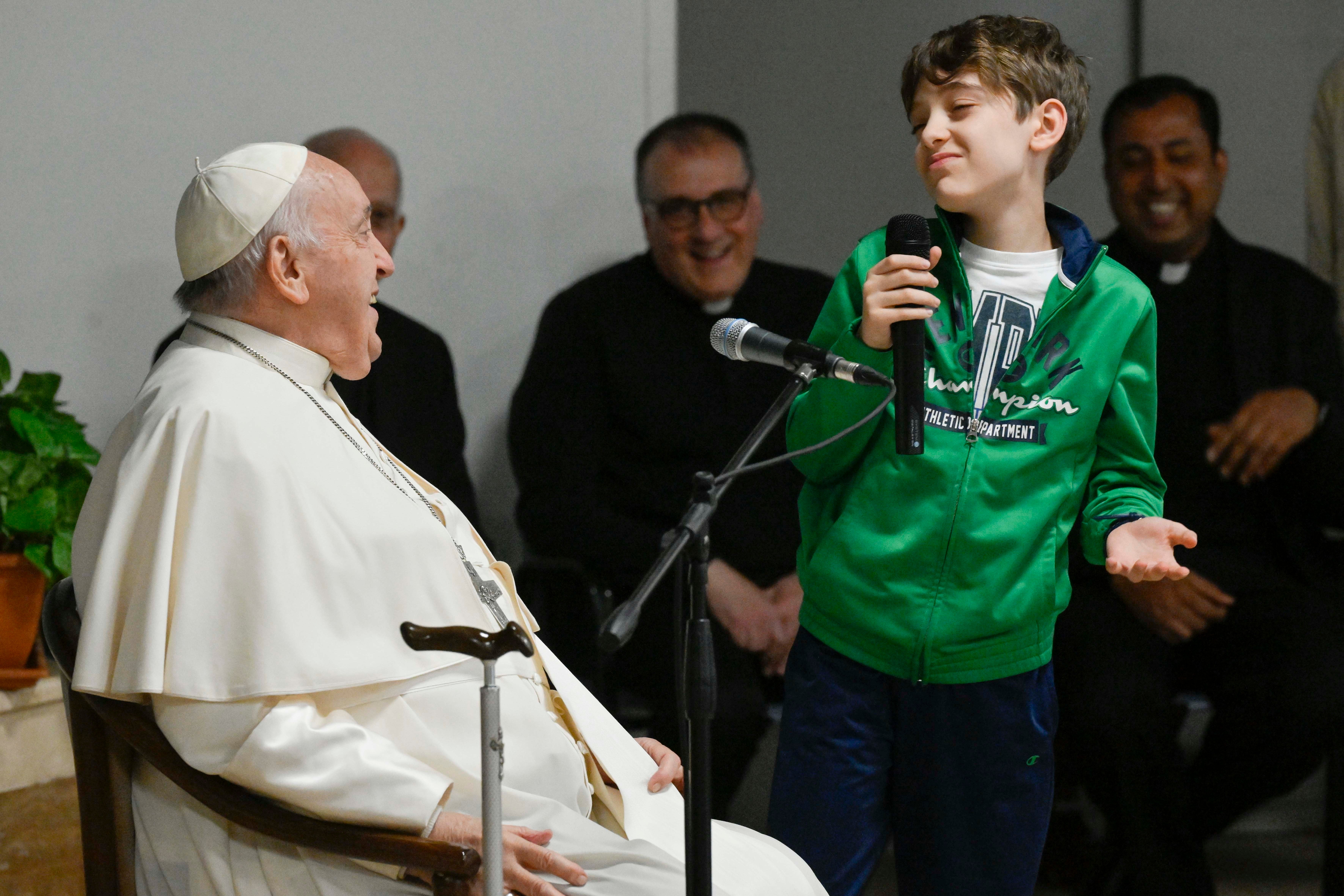 Pope Francis listens to a boy's question