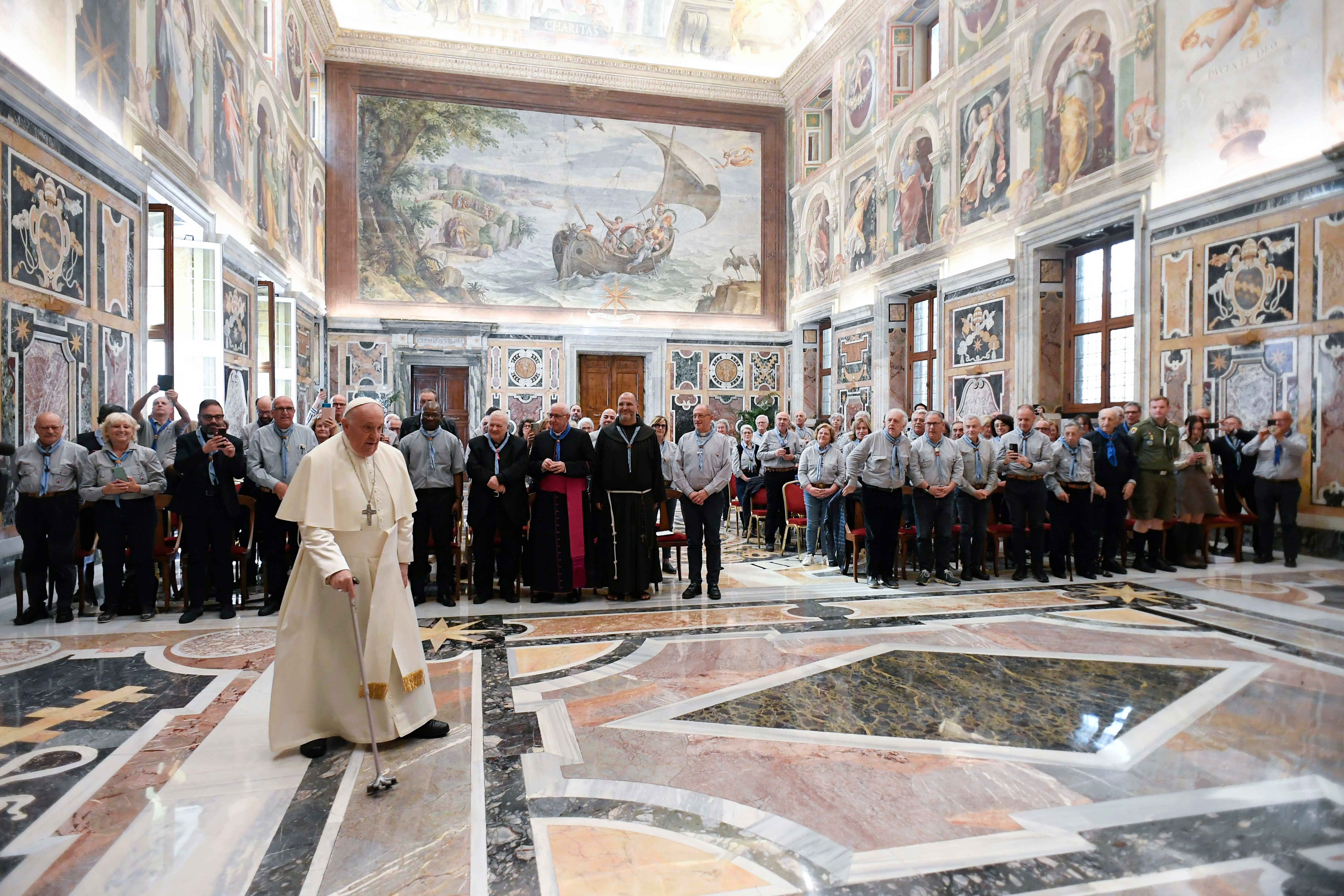 Pope Francis enters the Clementine Hall at the Vatican for a meeting with members of the Italian Catholic Movement of Adult Scouts.