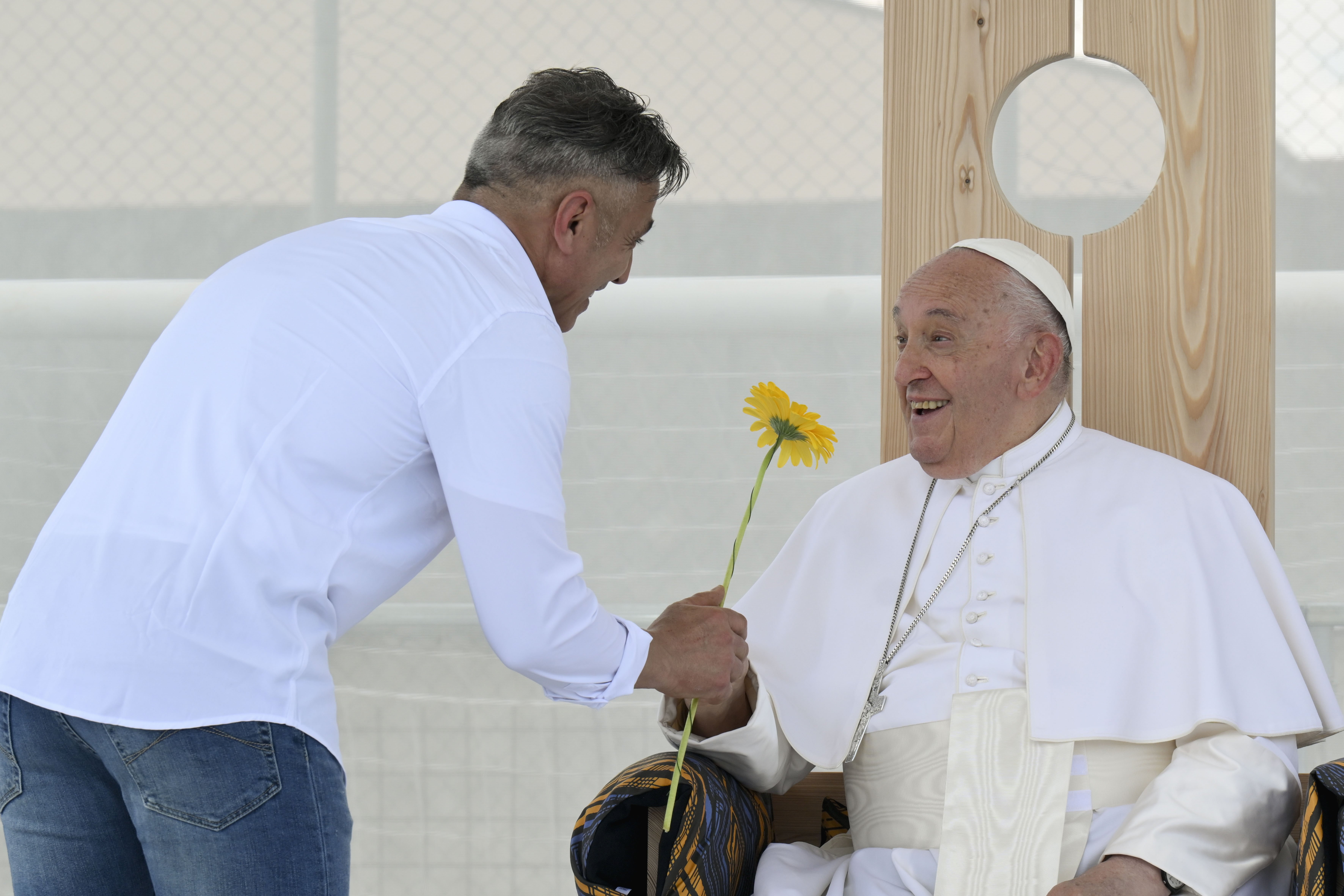 Pope Francis receives a flower from an inmate